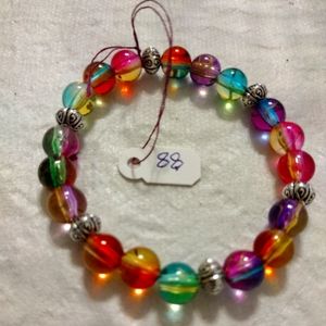 Artemis's Gems custom-made beaded bracelet with rainbow beads and silver spacers